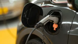 Close up photo of an electric vehicle charging port with charger attached