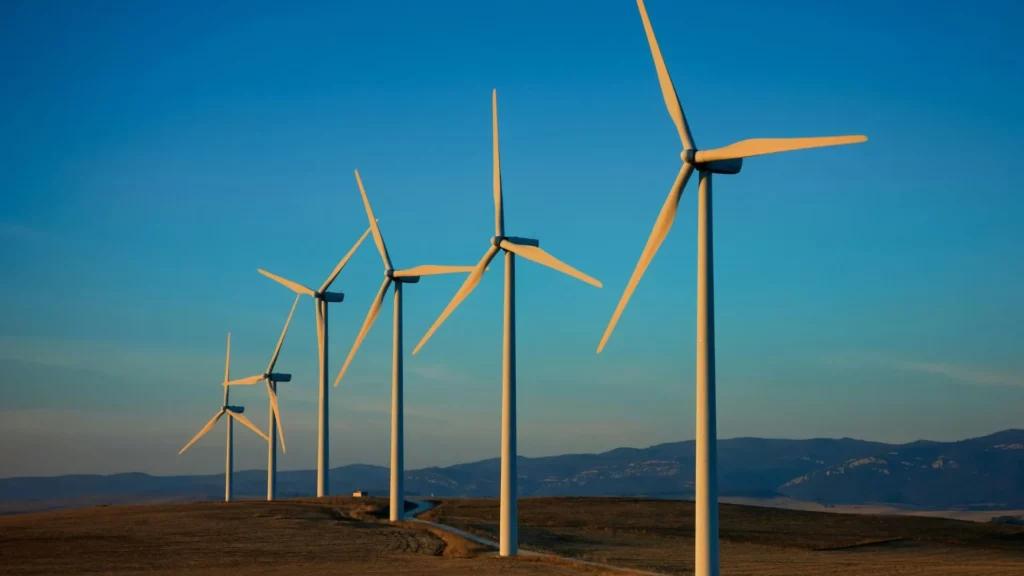 windmills on a hilltop photographed at sunset