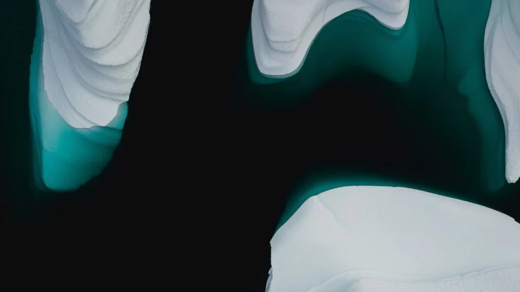 overhead view of icebergs floating in the arctic sea